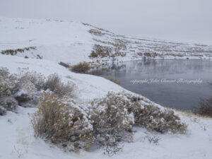 Snow-covered White Bluffs overlooking the Columbia River during winter at the Hanford Reach National Monument, photographed by John Clement